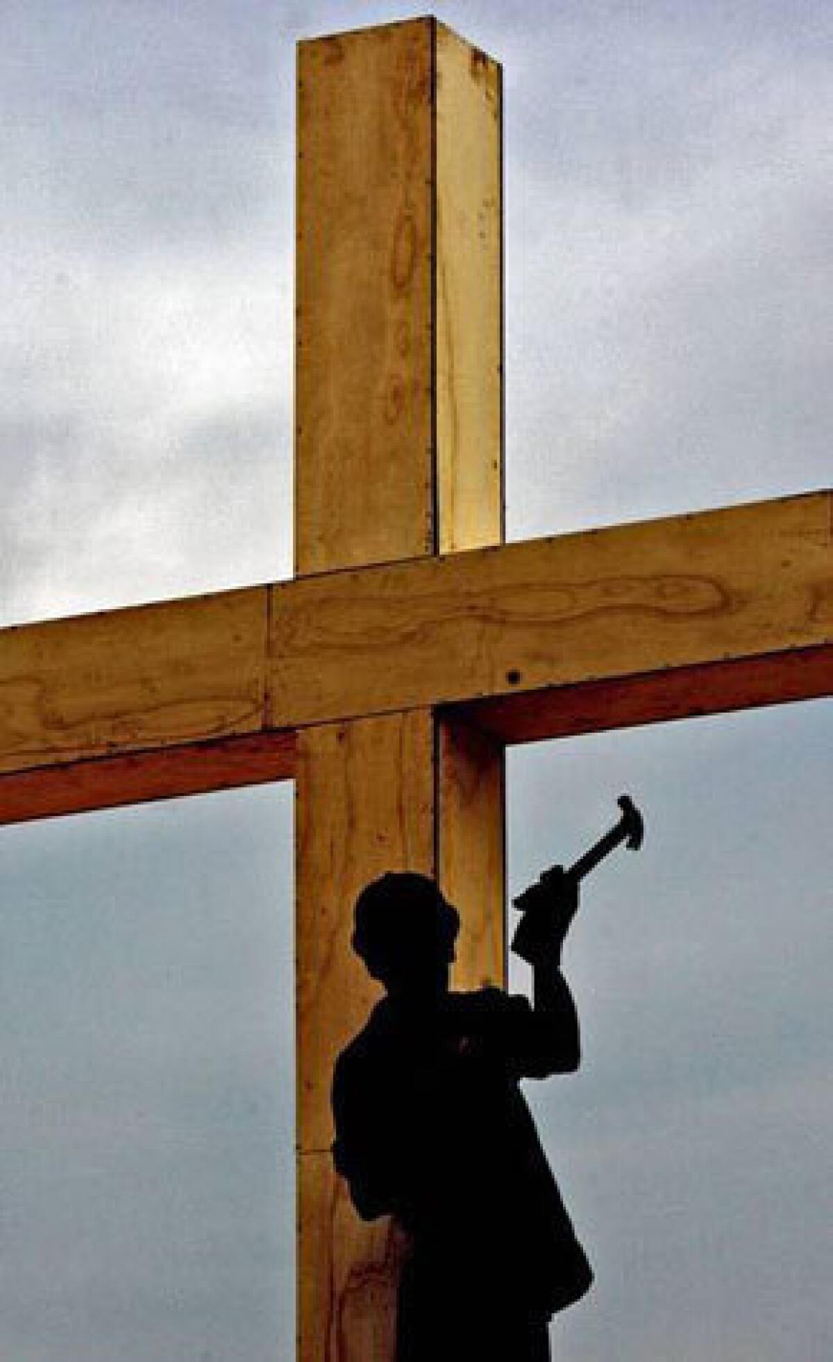 A worker in Sao Paulo, Brazil, puts the finishing touches on a cross in preparation for the 2007 visit by Pope Benedict XVI.