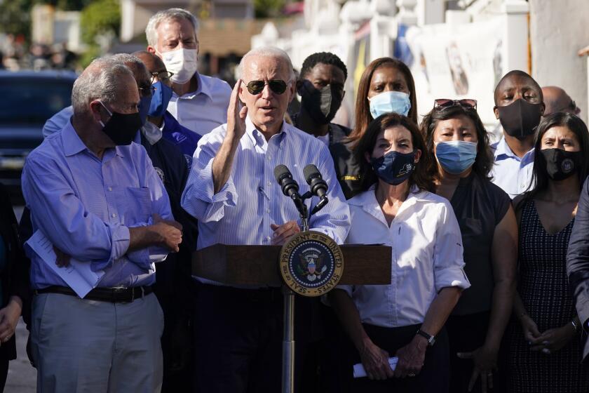 President Joe Biden speaks as he tours a neighborhood impacted by flooding from the remnants of Hurricane Ida, Tuesday, Sept. 7, 2021, in the Queens borough of New York. (AP Photo/Evan Vucci)
