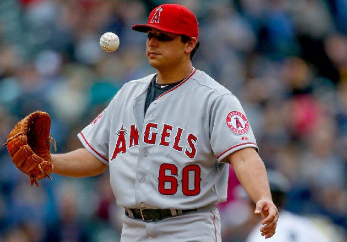 Angels pitcher Jason Vargas flips the ball after giving up a solo home run to Seattle Mariners' Jason Bay.