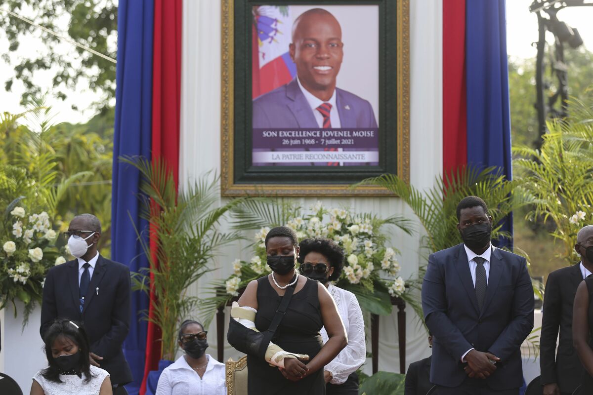 FILE - First lady Martine Moise, center, attends a memorial service for her late husband, President Jovenel Moise, at the National Pantheon Museum in Port-au-Prince, Haiti, July 21, 2021. A convicted drug trafficker pleaded guilty in U.S. federal court Friday, March 24, 2023, to participating in the assassination of Haitis president in 2021. (AP Photo/Odelyn Joseph, File)