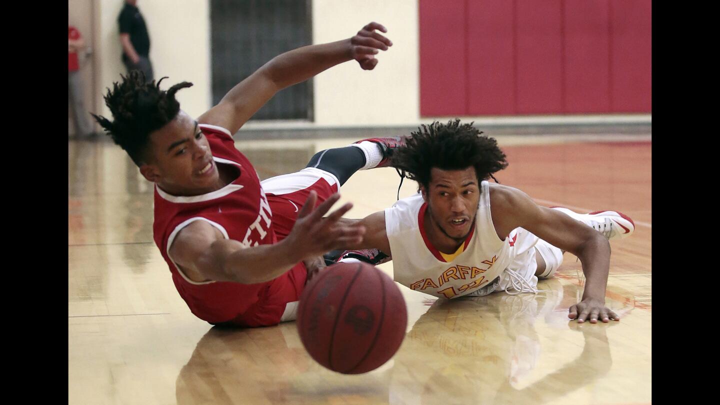 Fairfax player Antoine Monroe, right, battles Etiwanda's Miles Oliver for the ball during the semifinal of Southern California Regionals Open Division at Fairfax High School on Tuesday.
