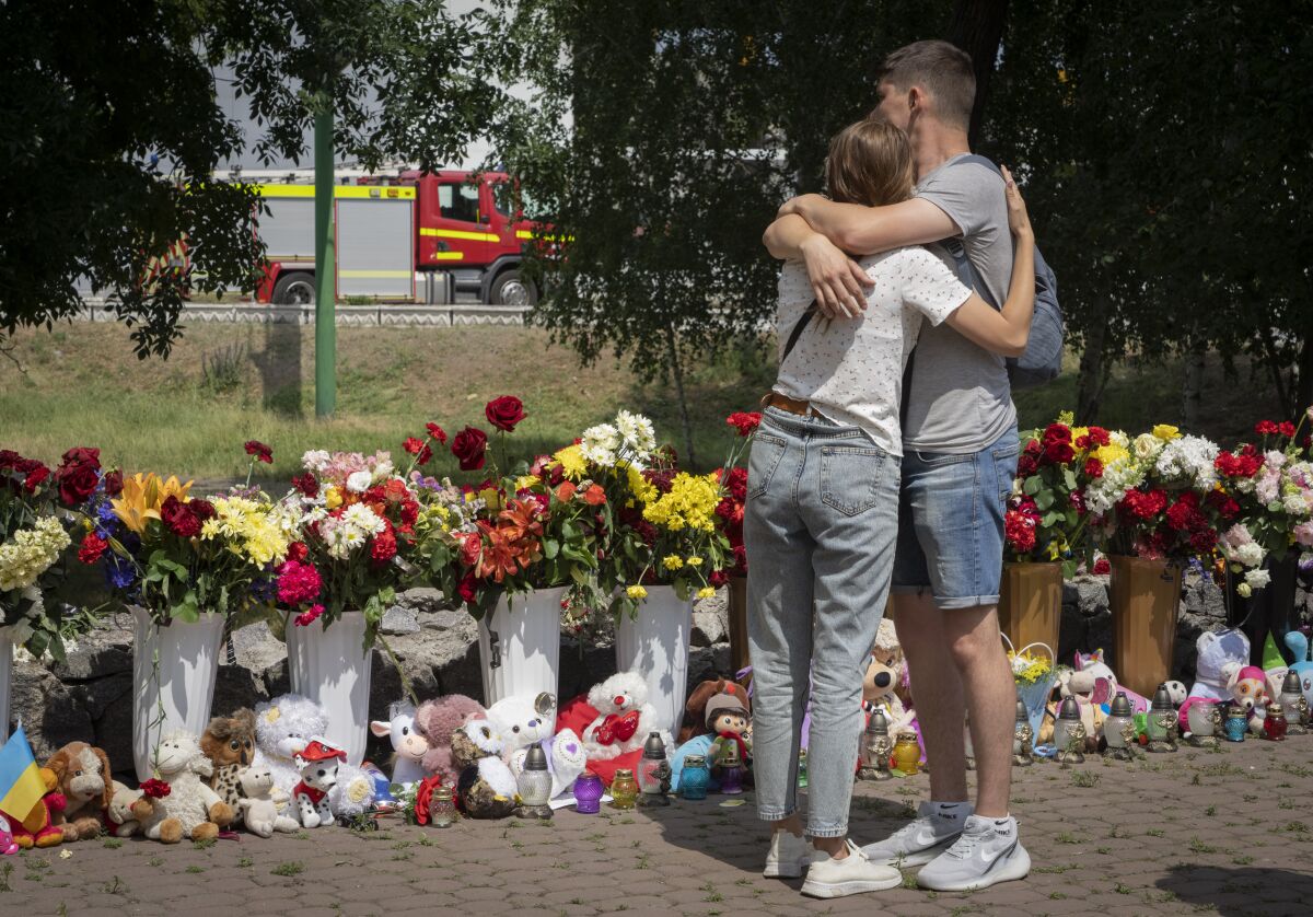 Mourners comforting each other