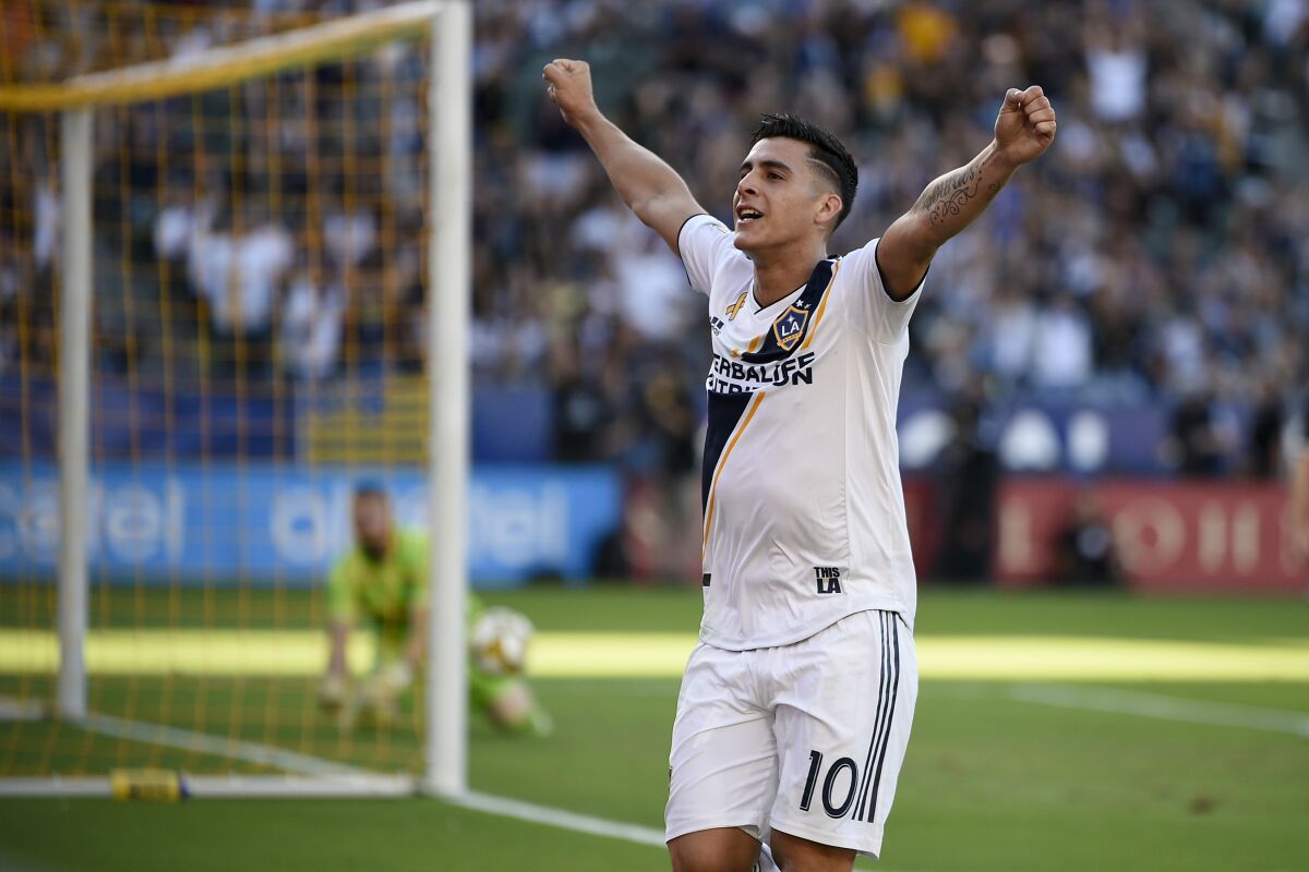 Galaxy defender Cristian Pavón (10) celebrates after assisting on a goal by Zlatan Ibrahimovic during the first half Sunday.