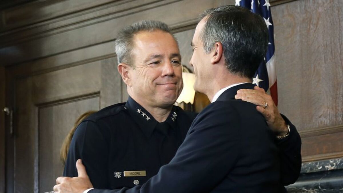 Los Angeles Mayor Eric Garcetti congratulates Michel Moore, left, in June after announcing the police veteran as his choice for chief.