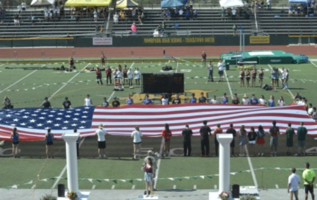 A U.S. flag is held on the field at Moorpark High.