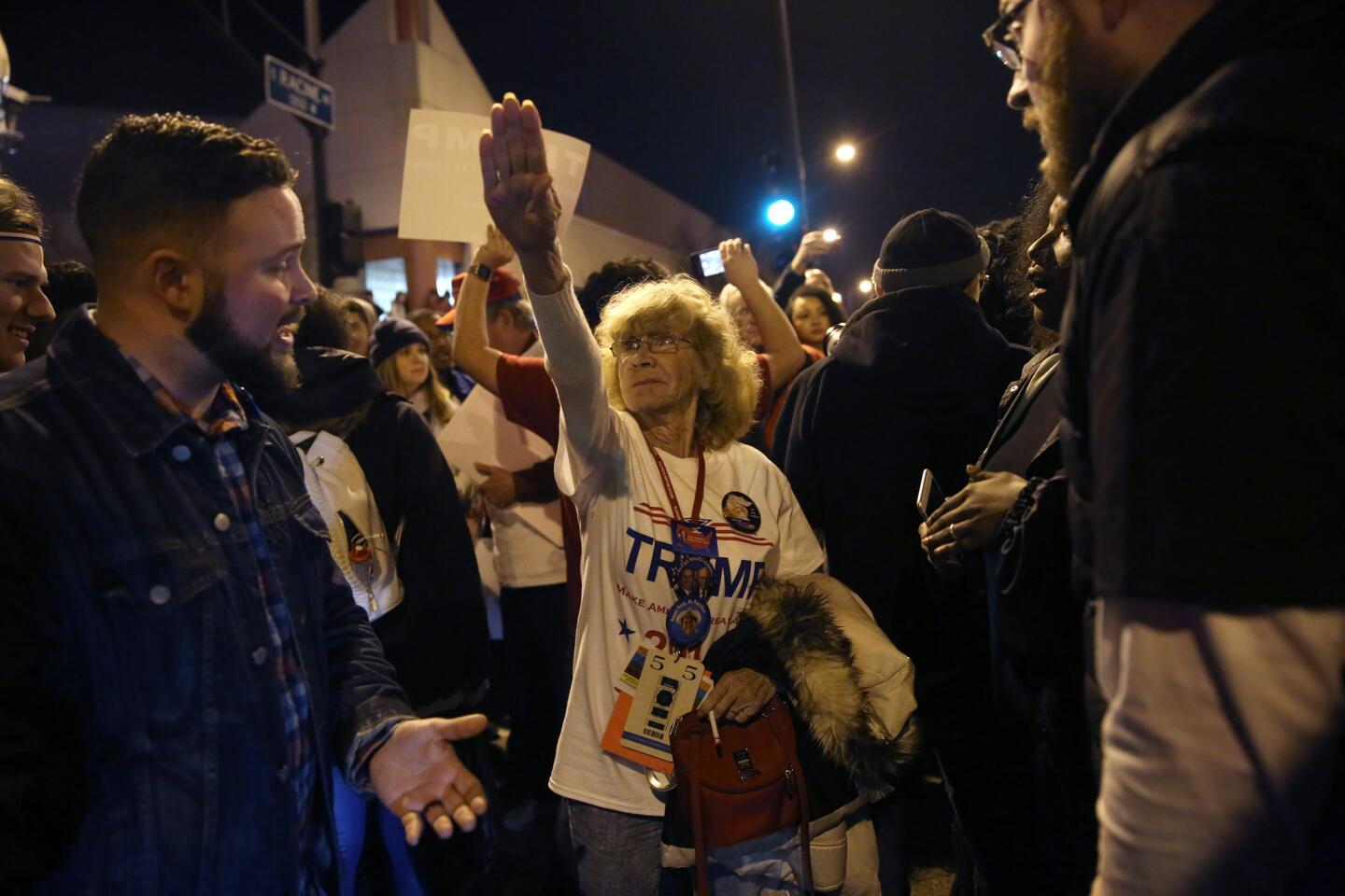 Donald Trump supporter Birgitt Peterson, center, of Yorkville, argues with protesters on March 11, 2016, outside the UIC Pavilion after the rally for the Republican presidential candidate was canceled.