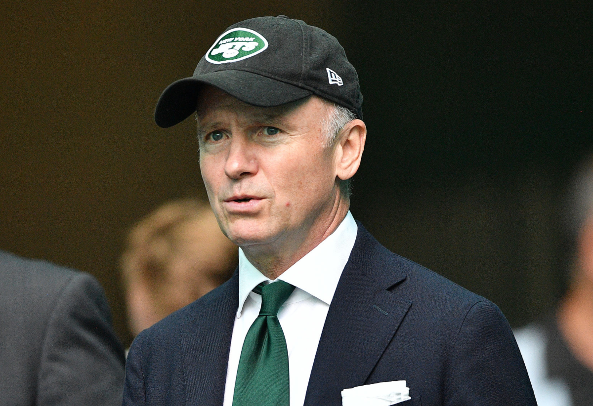 New York Jets owner Christopher Johnson takes to the field before a game.