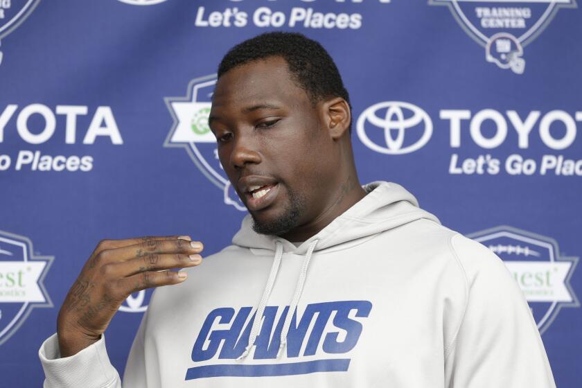 New York Giants defensive end Jason Pierre-Paul talks to reporters during an NFL football camp in East Rutherford, N.J., on July 24, 2014,
