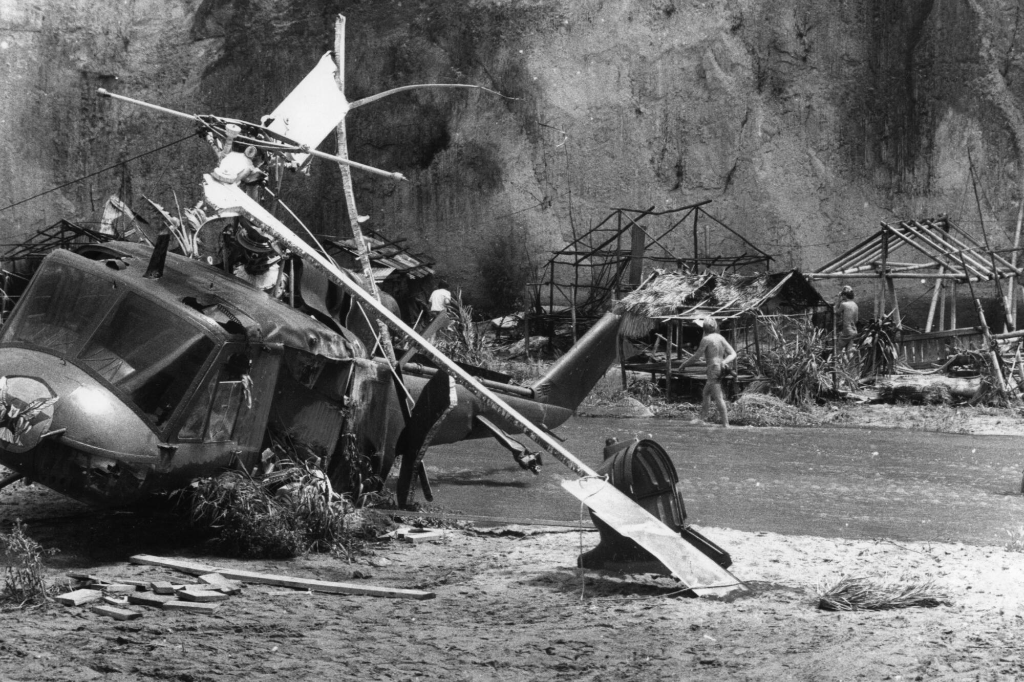 Helicopter wreckage and debris on the ground