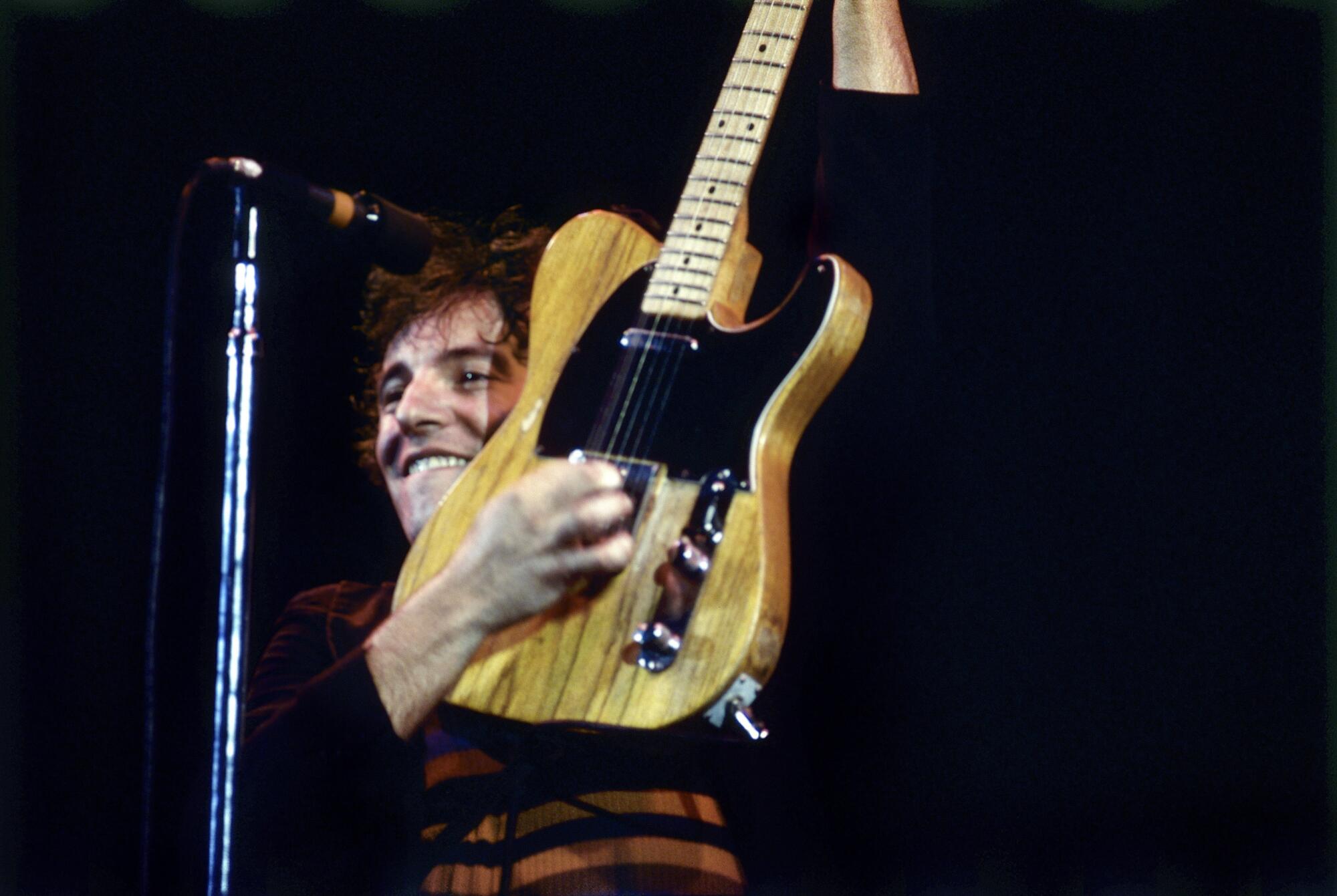 Bruce Springsteen plays his guitar onstage in 1978.