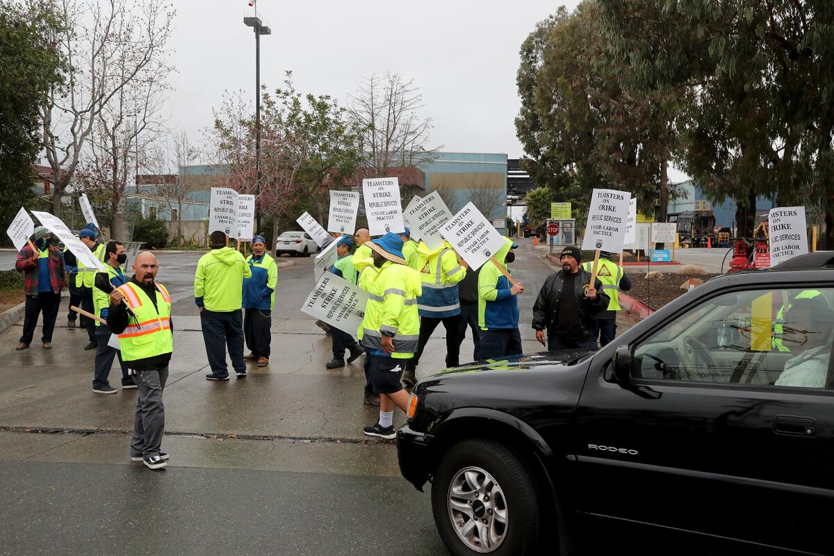 Members of Teamsters Local 396 picket outside the Republic Services facilities in Huntington Beach Dec. 9.