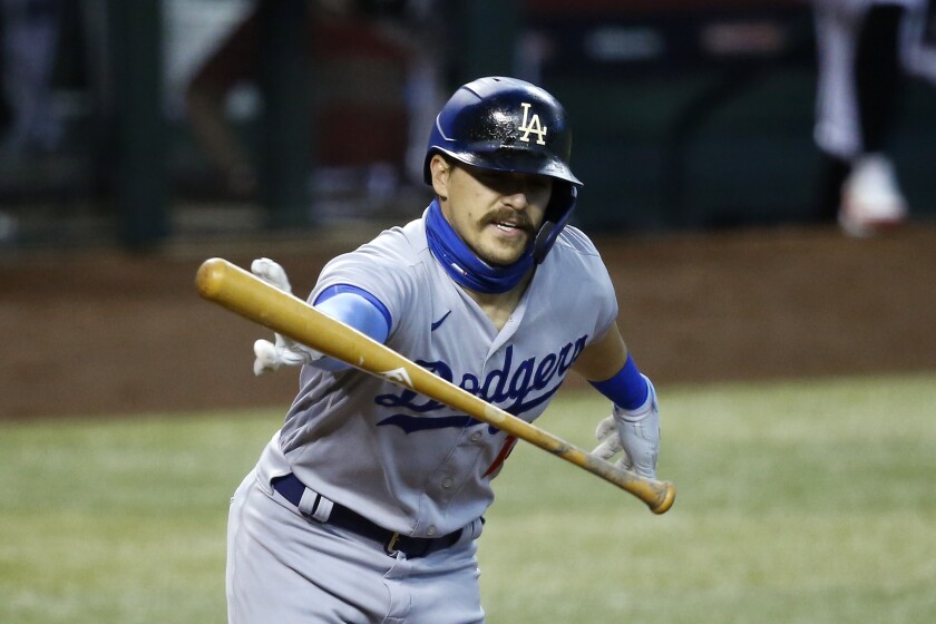 Dodgers second baseman Kiké Hernández tosses his bat away during a game.