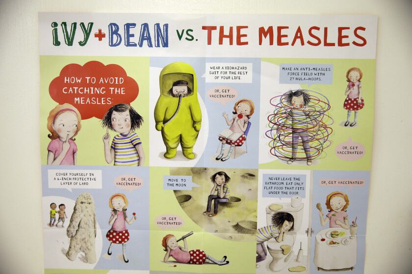 A poster about measles is displayed at the Tamalpais Pediatrics clinic in Greenbrae, Calif. Health officials are warning parents against considering "measles parties" to intentionally expose their children to the disease.