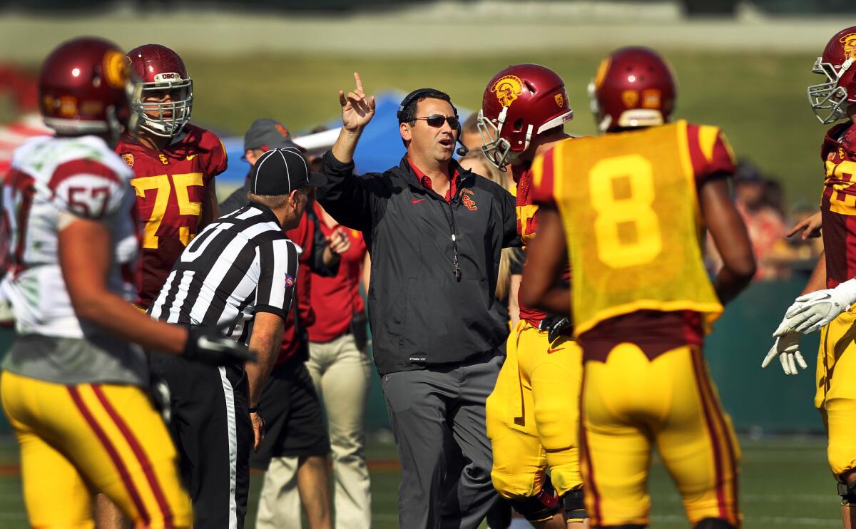 USC Coach Steve Sarkisian gives instructions to players during the spring game last year.