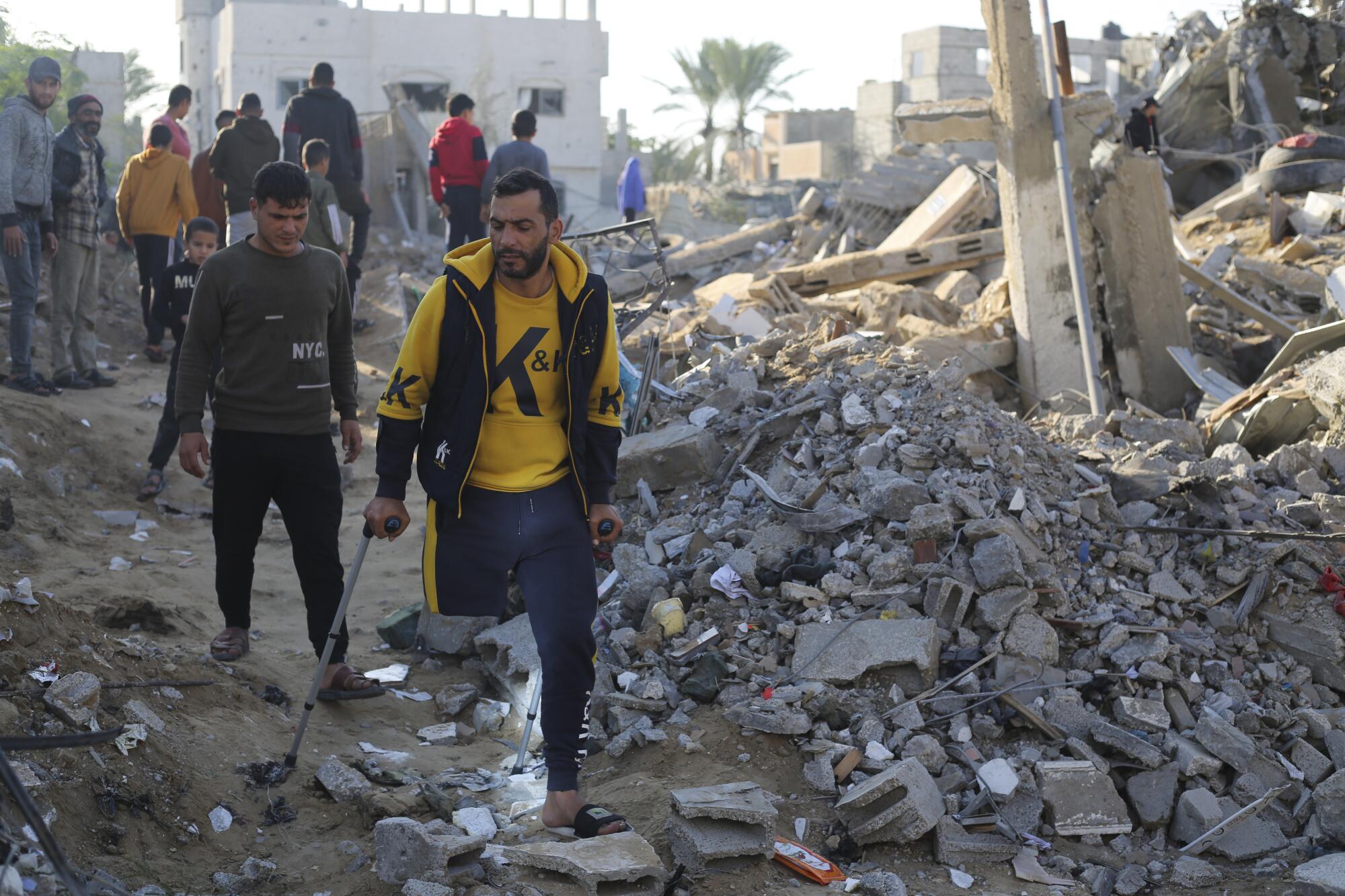 Gazans look at destruction from Israeli bombardment of Rafah