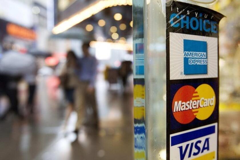 Plastic is welcome at this store in New York. Many consumers are paying more for using credit cards.