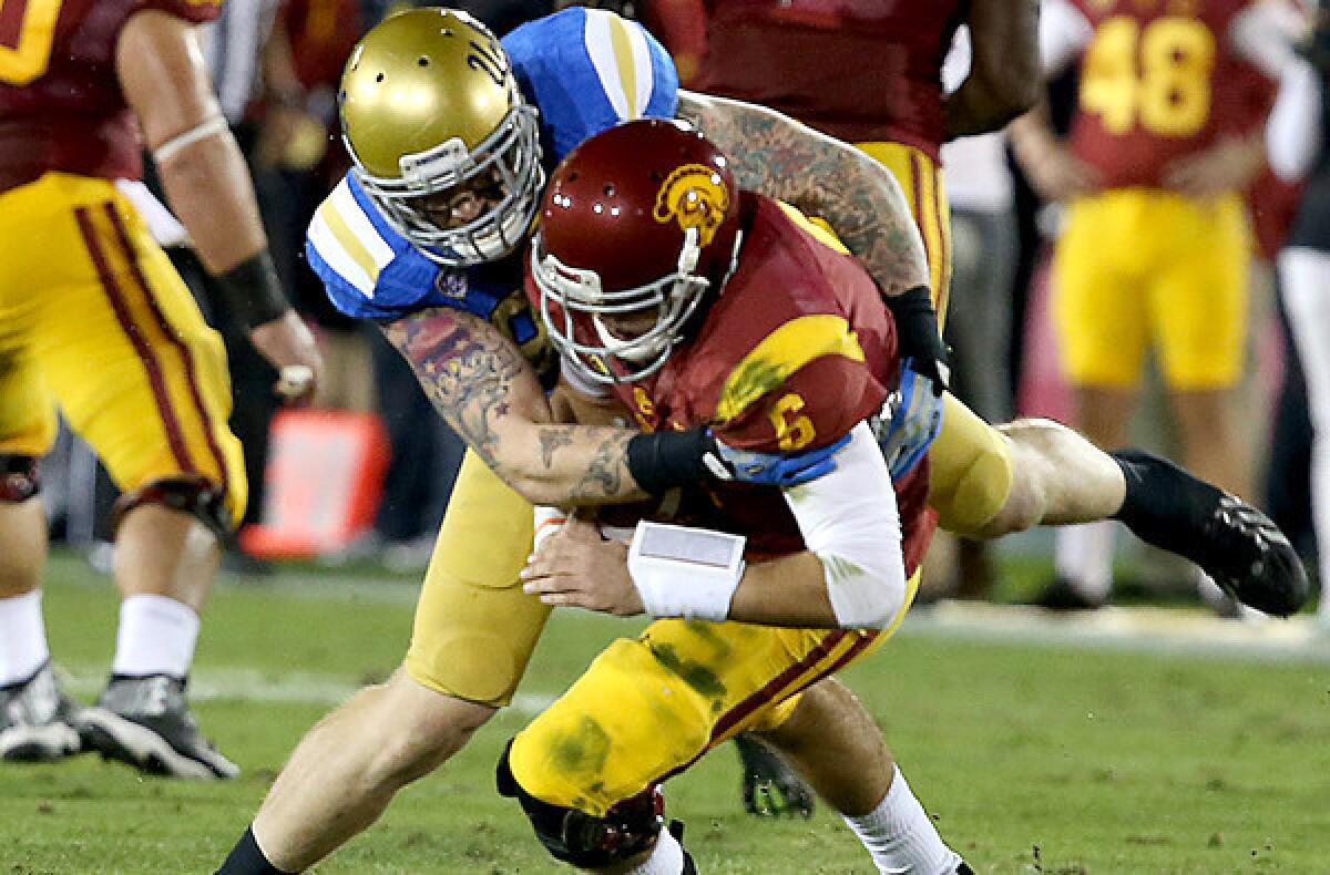 UCLA defensive end Cassius Marsh sacks USC quarterback Cody Kessler for the second time in the first quarter Saturday at the Coliseum.