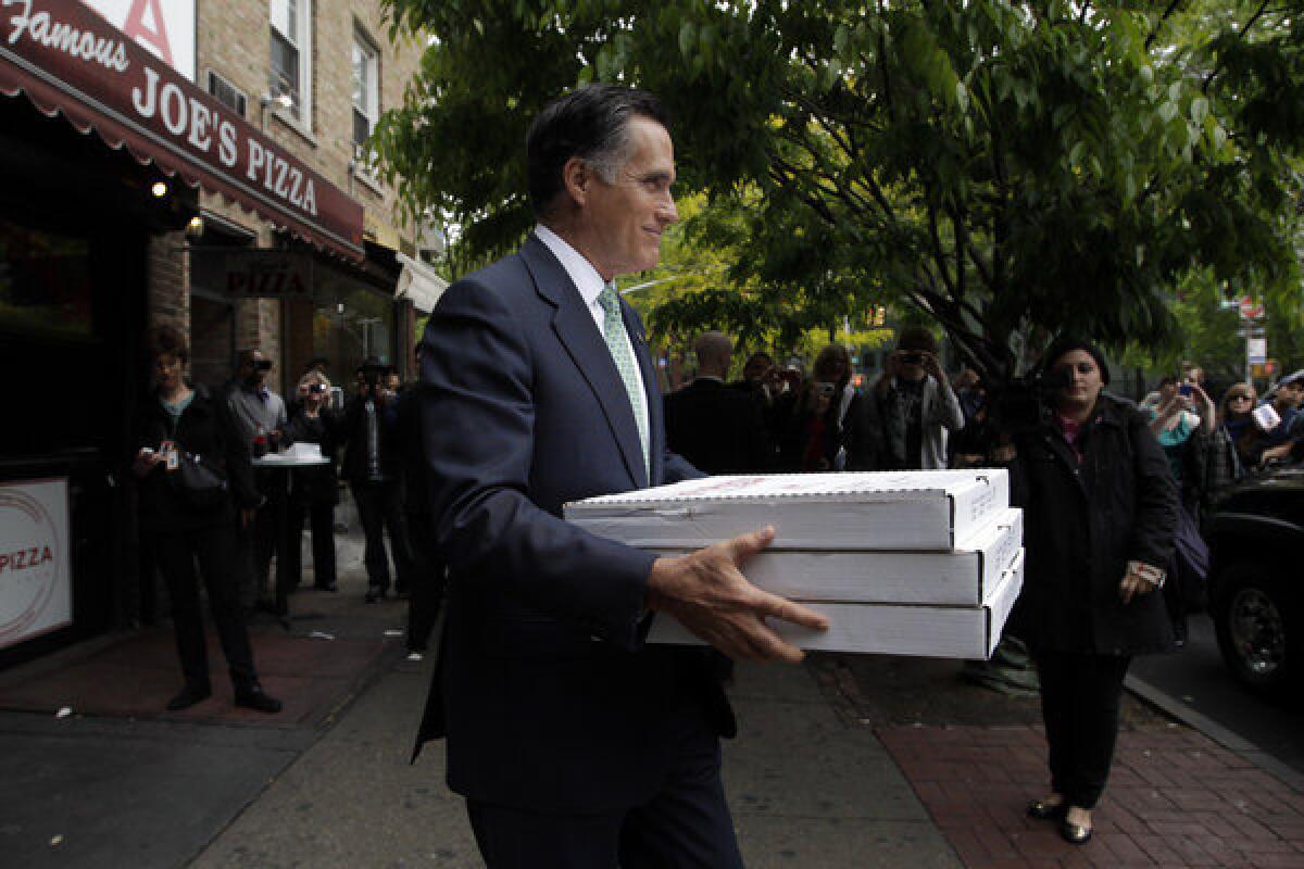Republican presidential candidate and former Massachusetts Gov. Mitt Romney brings pizza to a firehouse in New York.