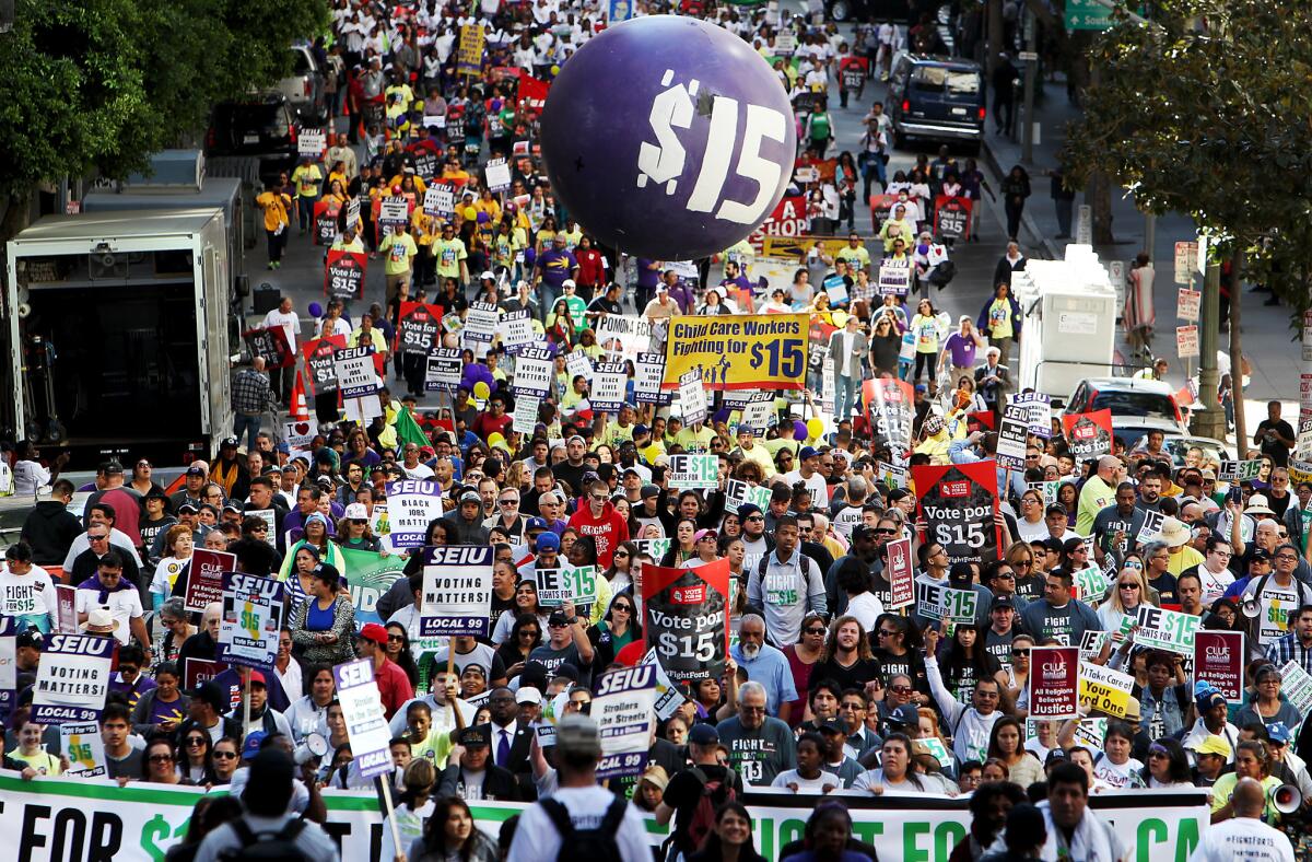 Workers march through the financial district of Los Angeles last November to press demands for a minimum wage of $15 per hour.