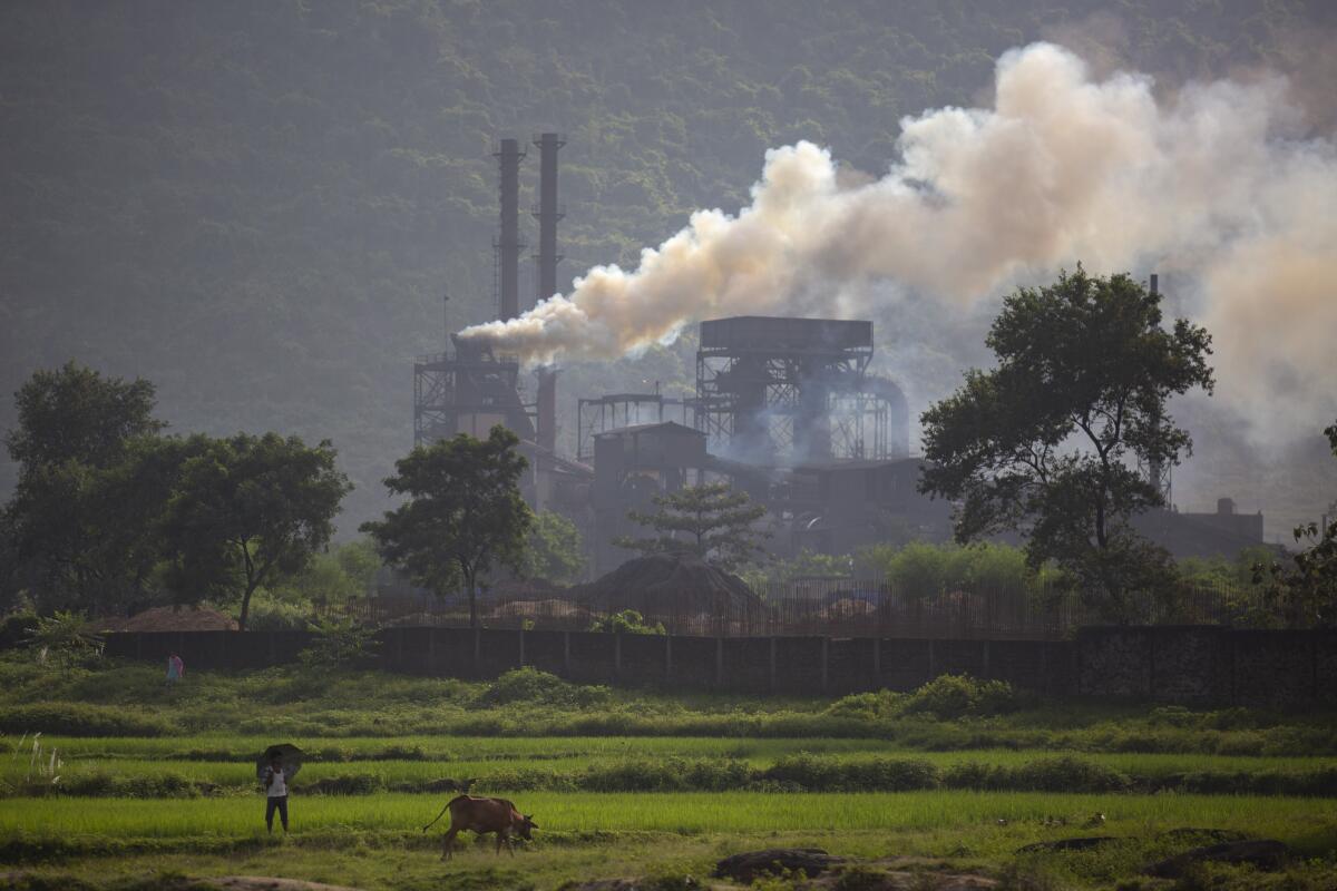 Smoke rises from a coal-powered steel plant near Ranchi, India.