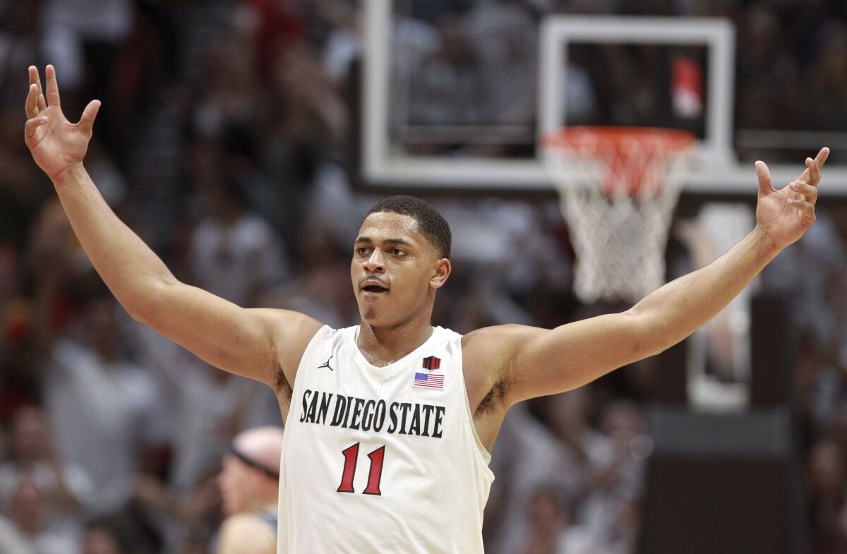 The Aztecs' Matt Mitchell puts his arms out as he celebrates the Aztecs' lead over Utah State during the second half at the Viejas Arena on Saturday. Mitchell had 28 points, 24 in the second half as San Diego State rallied to the victory.