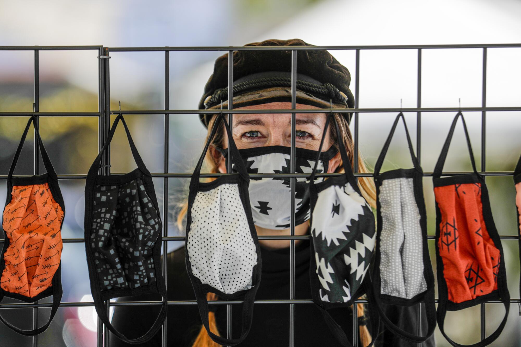 Alisun Franson sells face masks from a stand in front of her business Amiga Wild in Venice.
