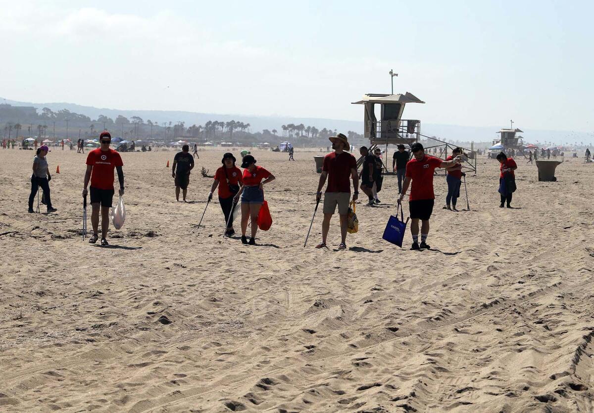 Employees from the Orange County Target company volunteer their time walking through the Huntington Beach State Beach.
