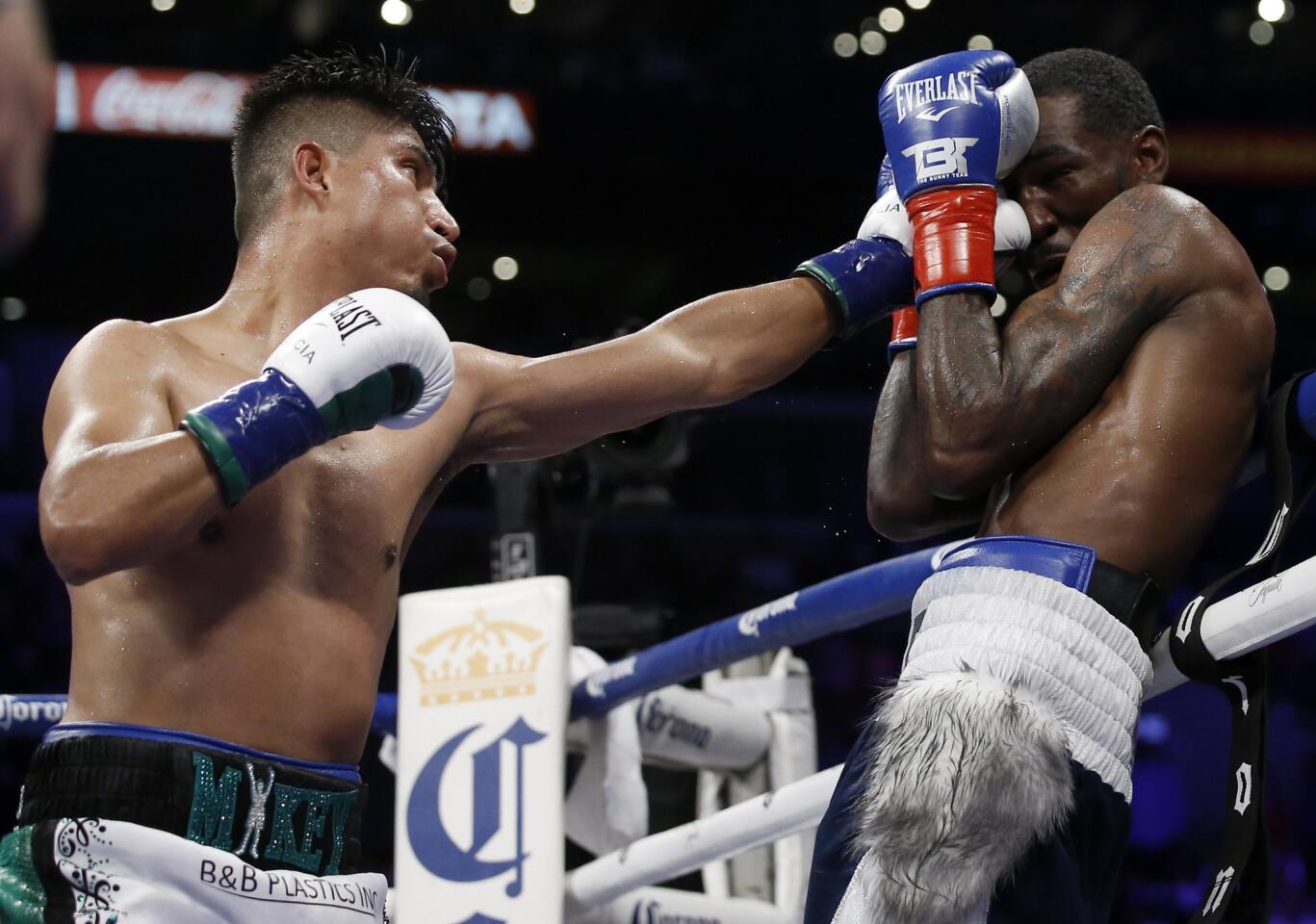 Mikey Garcia hits Robert Easter Jr. with a jab during the 11th round in their WBC and IBF world lightweight title bout in Los Angeles, Saturday, July 28, 2018. Garcia won by unanimous decision.