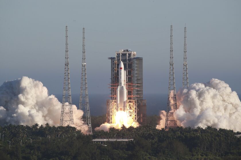 In this photo released by Xinhua News Agency, China's new large carrier rocket Long March-5B blasts off from the Wenchang Space Launch Center in southern China's Hainan Province, May 5, 2020. The Long March-5B made its maiden flight on Tuesday, sending the trial version of China's new-generation manned spaceship and a cargo return capsule for test into space. (Tu Haichao/Xinhua via AP)