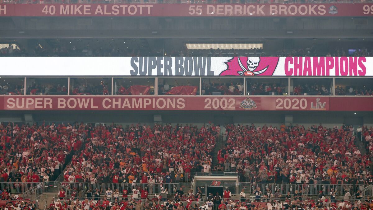 The Tampa Bay Buccaneers uncover their 2020 Super Bowl banner before an NFL football game.