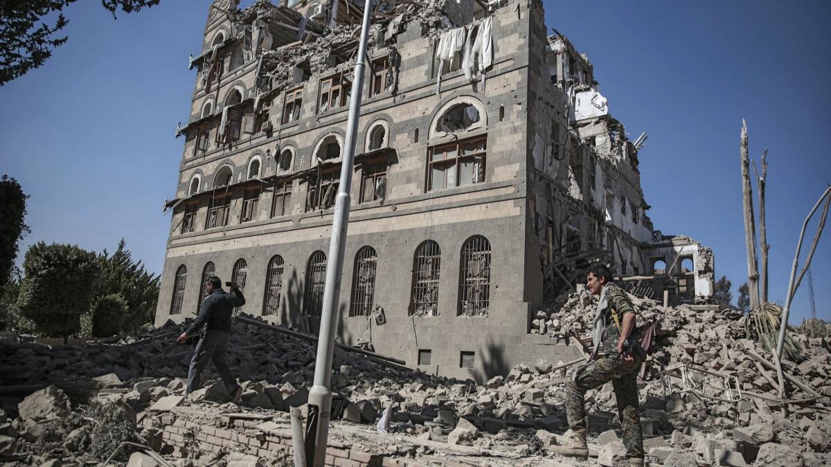 Houthi Shiite rebels inspect the rubble after Saudi-led airstrikes on the Republican Palace in Sana, Yemen, in December.