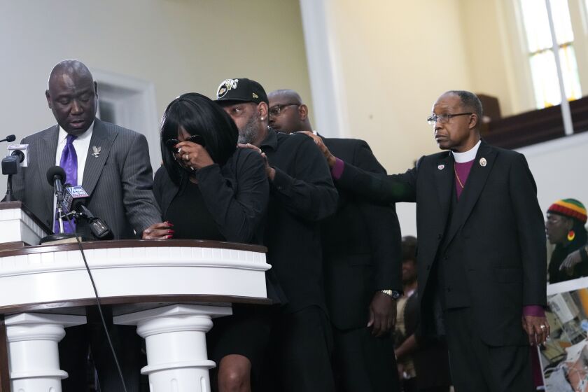 RowVaugn Wells, second from left, mother of Tyre Nichols, who died after being beaten by Memphis police officers, cries as she is comforted by Tyre's stepfather Rodney Wells, behind her, at a news conference with civil rights Attorney Ben Crump, left, in Memphis, Tenn., Monday, Jan. 23, 2023. Far right is Bishop Henry Williamson. (AP Photo/Gerald Herbert)