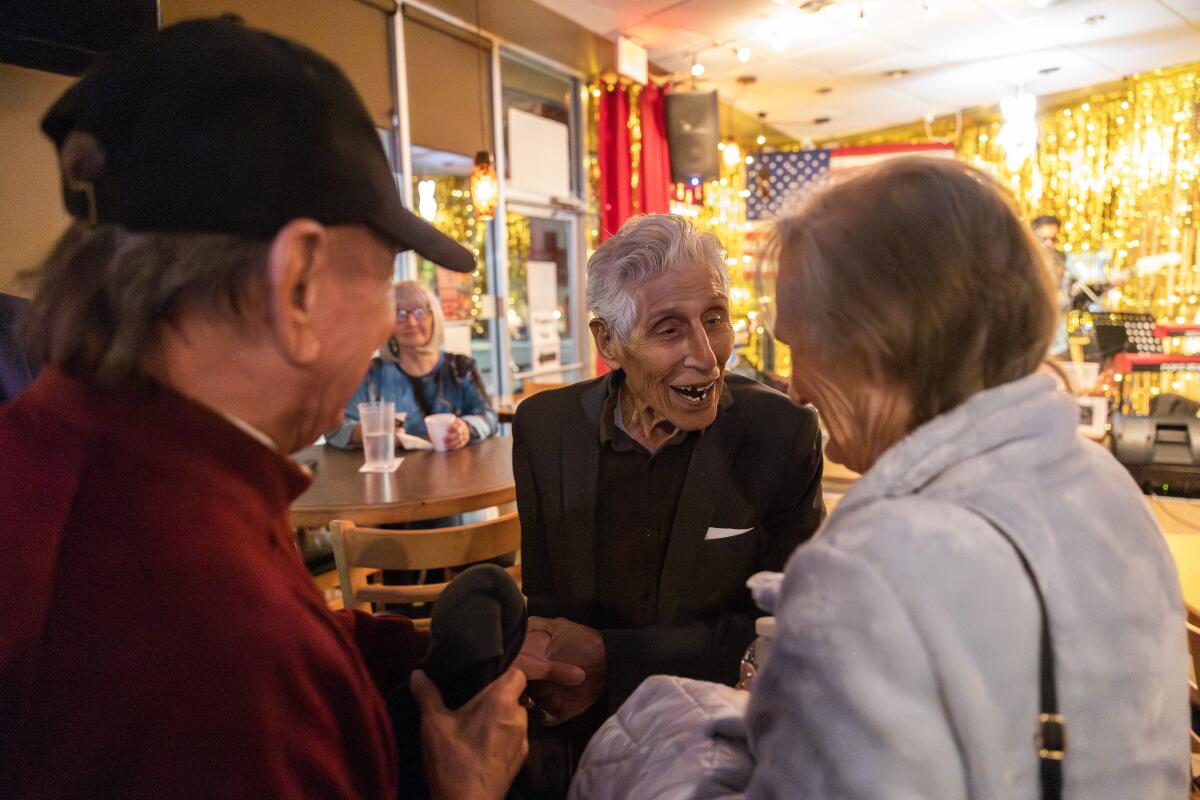 Pearl Harbor survivor Bob Fernandez, 100, says good night to friends after a night of dancing and singing on Nov. 21.