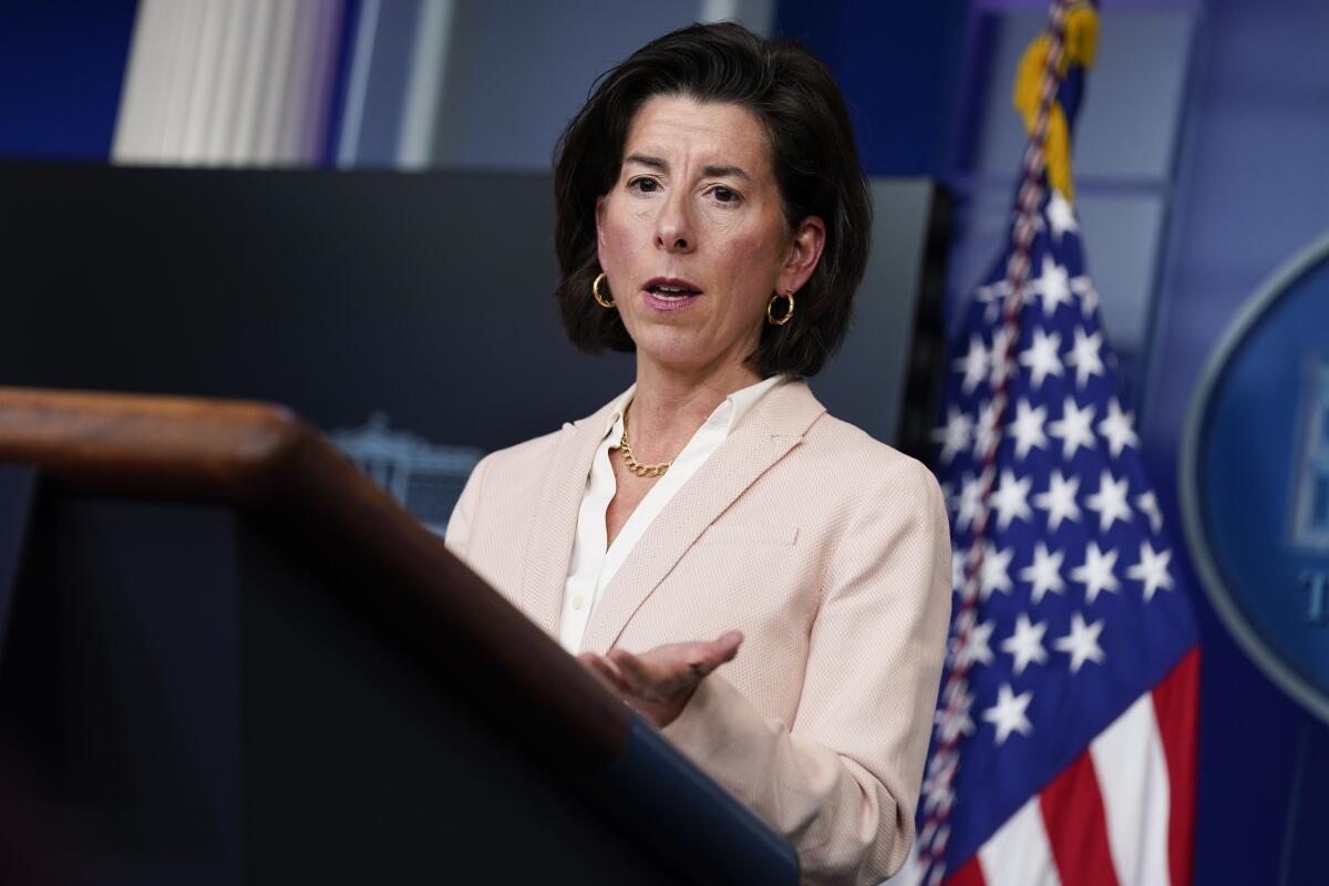 U.S. Commerce Secretary Gina Raimondo speaks from a podium.