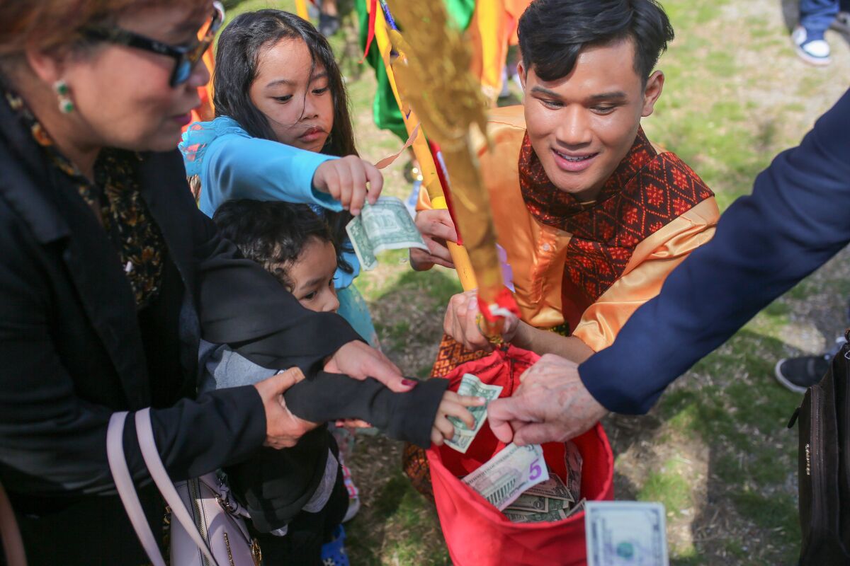 Audience members donate money to the Cambodian dance group at the Khmer New Year event.