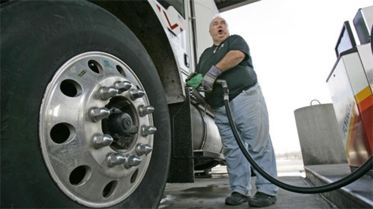 STICKER SHOCK: Trucker Mike Monnin fills his tank with diesel that cost $3.959 a gallon Monday near Buffalo, N.Y. Nationwide, diesel fuel is at a record average of $3.658 a gallon.