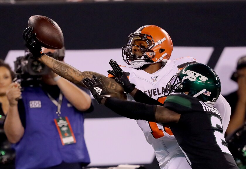Cleveland Browns wide receiver Odell Beckham Jr. makes a catch over New York Jets cornerback Nate Hairston during Monday’s game.