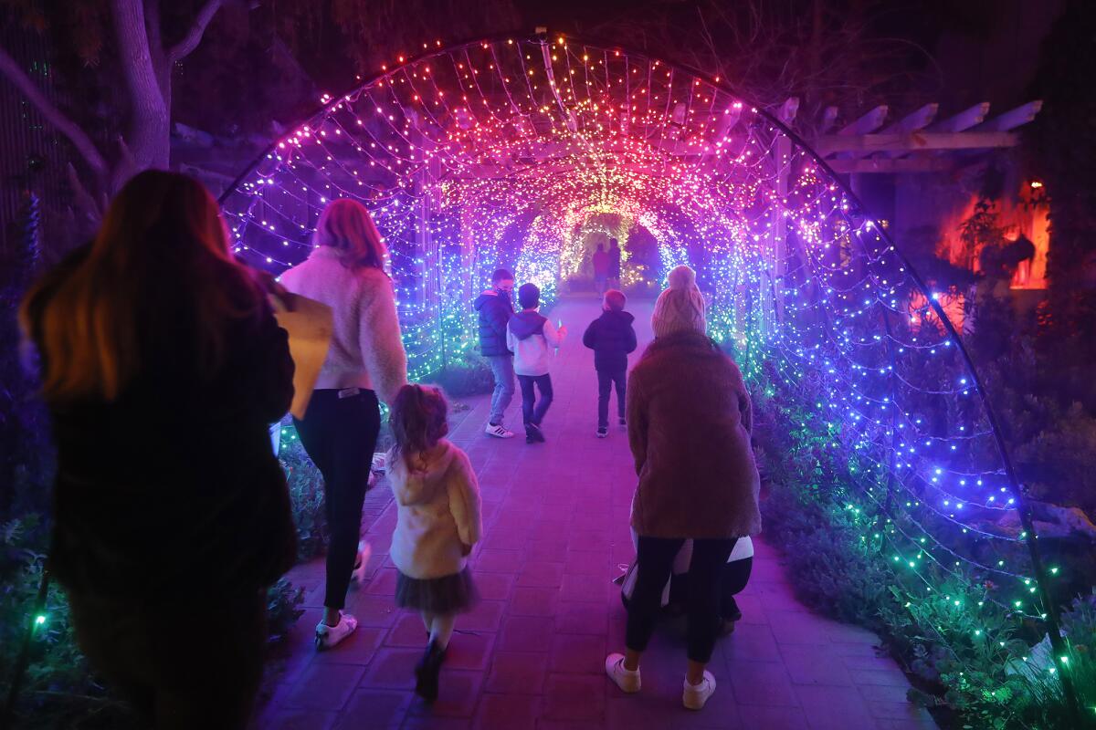 Guests walk down the Technicolor light tunnel.