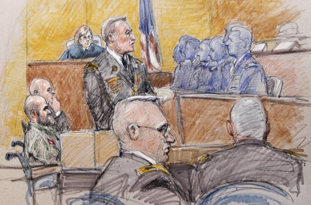 U.S. Army Maj. Nidal Malik Hasan, left, sits while prosecutor Maj. Larry Downend questions potential jurors in Ft. Hood, Texas, in a courtroom sketch.