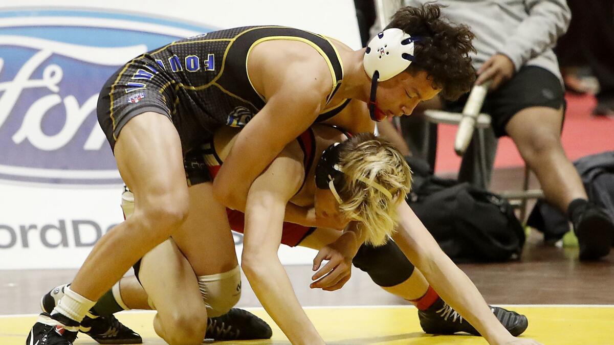 Fountain Valley High sophomore wrestler Max Wilner, left, shown competing on Feb. 23, helped the Barons win the West Torrance Duals on Wednesday.