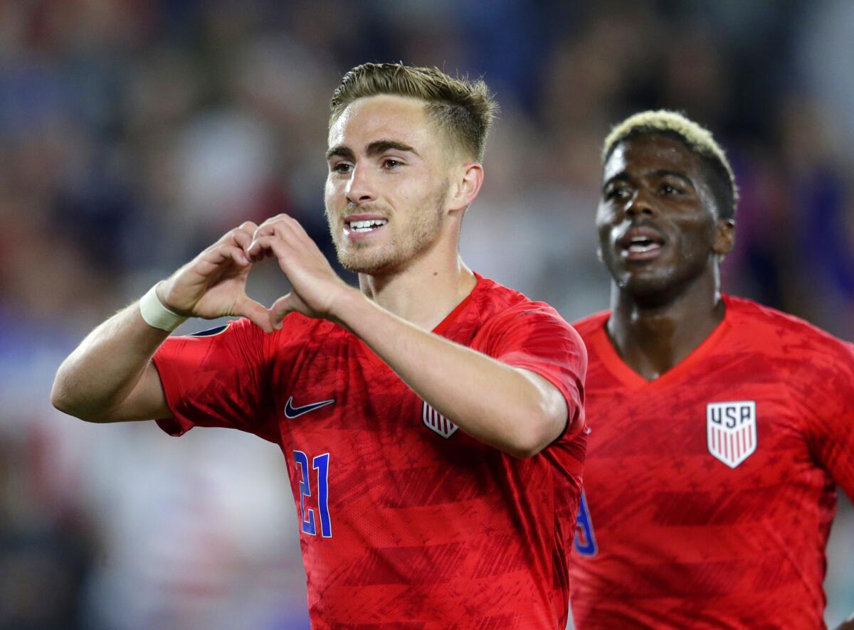 United States' Tyler Boyd, left, celebrates his goal against Guyana with fans as teammate Gyasi Zardes follows during the second half of a CONCACAF Gold Cup soccer match Tuesday, June 18, 2019, in St. Paul, Minn.