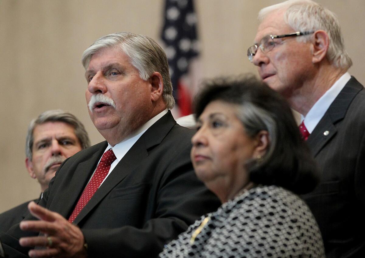 Interim Sheriff John Scott, center, is flanked by L.A. County Supervisors Zev Yaroslavsky, left, Gloria Molina and Mike Antonovich during a January press conference.