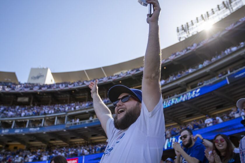 LOS ANGELES, CALIF. -- THURSDAY, MARCH 28, 2019: Dodgers fan Elliott Kirschenmann, of Bakersfield, celebrates Enrique Hern?ndez's seventh-inning home run on opening day as the Dodgers play the Diamondbacks at Dodger Stadium in Los Angeles, Calif., on March 28, 2019. (Allen J. Schaben / Los Angeles Times)