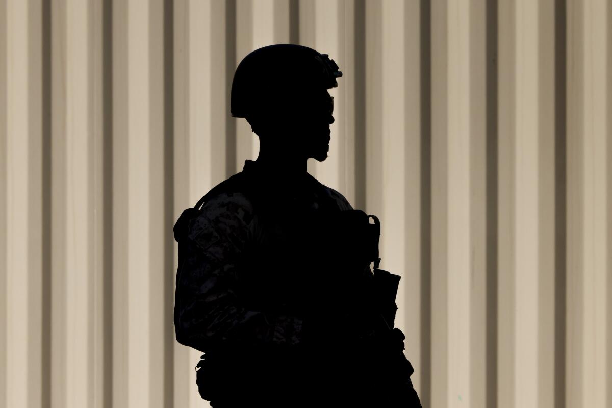 soldier stands guard outside the Wilshire Federal Building