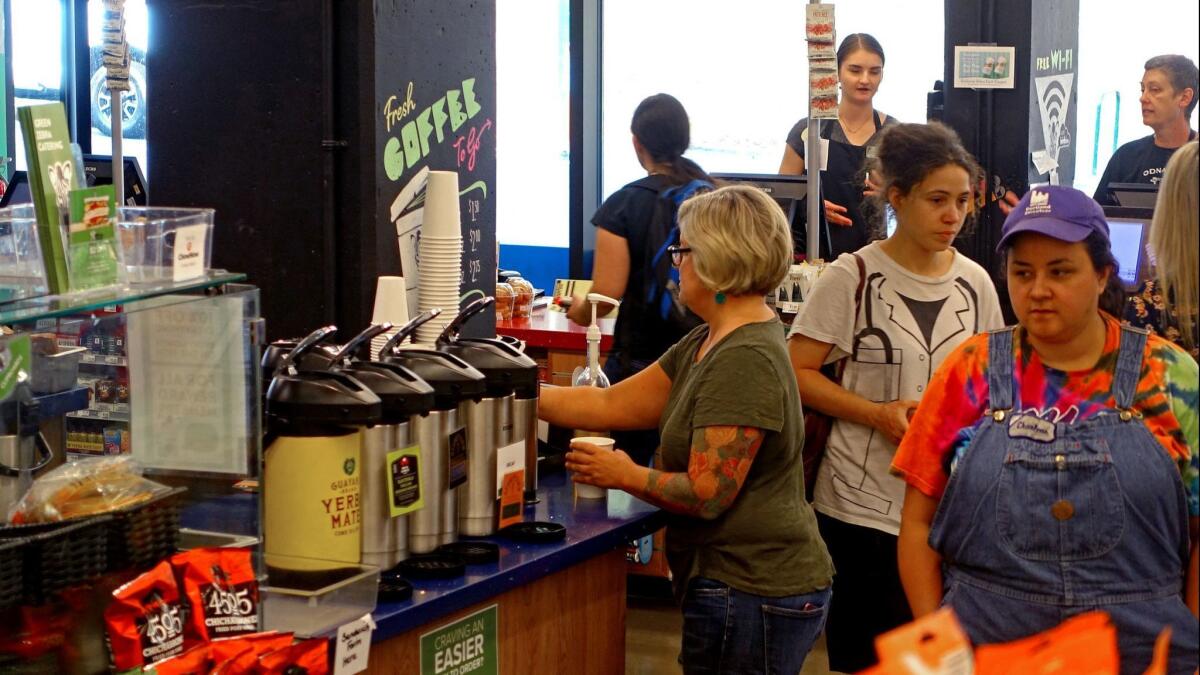 Green Zebra Grocery's founder, Lisa Sedlar, hits the store's coffee bar, which features java from Portland favorite Stumptown Coffee Roasters.