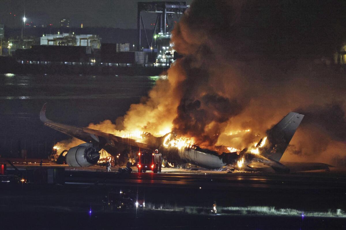 A plane on fire on a runway