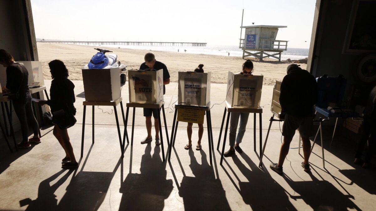 Voters line up to casts their ballots near the Venice Pier in Venice, Calif. on Nov. 6, 2018.