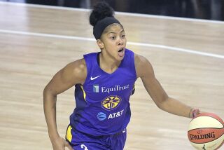 Los Angeles Sparks forward Candace Parker (3) sets up a play during the first half of a WNBA basketball game.