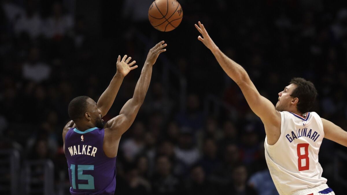 Charlotte's Kemba Walker shoots over the Clippers' Danilo Gallinari during the first half on Tuesday.