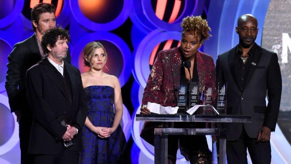 Dee Rees, second from right, accepts the Robert Altman award for "Mudbound" at the 33rd Film Independent Spirit Awards on Saturday, March 3, 2018, in Santa Monica, Calif. Looking on from far left are Garrett Hedlund, Billy Hopkins, Ashley Ingram and Rob Morgan.